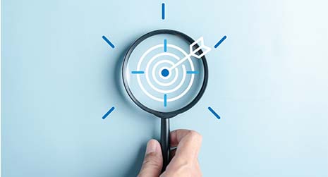 A magnifying glass with a bullseye in the viewing area